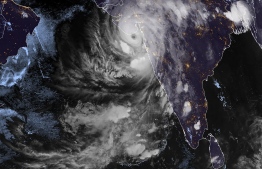 This RAMMB/CIRA handout satellite image shows Cyclone Tauktae over western India on May 17, 2021 at 14:45 UTC. - A major cyclone packing ferocious winds and threatening a destructive storm made landfall in western India on May 17, 2021, disrupting the country's response to its devastating Covid-19 outbreak. At least 12 people died over the weekend and on May 17, 2021 in torrential rains and winds as Cyclone Tauktae, according to press reports the biggest to hit western India in 30 years, swept over the Arabian Sea with Gujarat state in its sights. (Photo by Handout / RAMMB/CIRA / AFP) / 