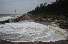 Waves overflow onto a damaged sea front after Cyclone Yaas hit India's eastern coast in the Bay of Bengal in Digha, some 190 km from Kolkata on May 27, 2021.
Dibyangshu SARKAR / AFP