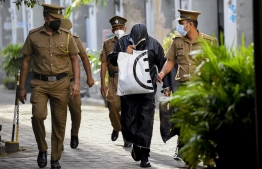 Former State Minister of Finance and former Chairman of Dhiraagu Mohamed Ashmalee being escorted by the Police after his hearing in court -- Photo: AFP