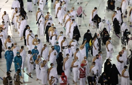 Muslim pilgrims circumambulate around the Kaaba, Islam's holiest shrine, at the Grand mosque in the holy Saudi city of Mecca during the annual hajj pilgrimage, on July 17, 2021. - The annual hajj pilgrimage, one of the five pillars of Islam, started with just 60,000 vaccinated Saudi residents allowed to take part this year because of the pandemic. For the second year in a row, Muslims from abroad have been excluded from the hajj, which drew 2.5 million pilgrims to Saudi Arabia in 2019 before the virus struck. (Photo by Fayez Nureldine / AFP)