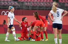 Canada's players celebrate their win in the Tokyo 2020 Olympic Games women's semi-final football match between the United States and Canada at Ibaraki Kashima Stadium in Kashima on August 2, 2021 -- Photo: Kazuhiro Nogi/AFP