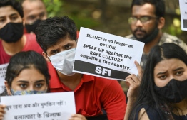 (FILE) Activists of Student Federation of India (SFI) hold placards during a protest against the alleged rape and murder of a nine-year-old girl, in New Delhi on August 4, 2021: the police officer that is accused of raping the 13 year old rape victim is arrested, while all other officers in the station when she was attacked has been suspended -- Photo by Prakash Singh / AFP