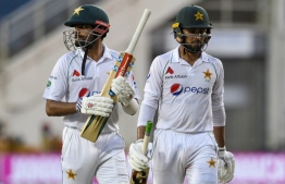 Babar Azam (L) and Faheem Ashraf (R) of Pakistan walk off the field at the end of day 3 of the 1st Test between West Indies and Pakistan at Sabina Park, Kingston, Jamaica, on August 14, 2021 -- Photo: Randy Brooks/ AFP