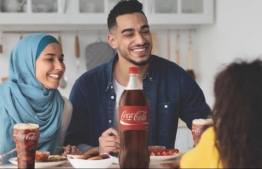 Promotional photo provided by Coca-Cola of people enjoying their meal with Cola -- Photo: Coca-Cola