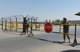 Uzbek soldiers guard a checkpoint, two kilometres from "Friendship Bridge" over the Amu Darya river, which separates Uzbekistan and Afghanistan near Termez on August 15, 2021. Residents of an Uzbek city near the Afghan border woke up to the prospect of having the Taliban as neighbours once again as the militant group neared completing its military takeover of Afghanistan. Former Soviet Uzbekistan is one of three Central Asian countries that share a border with Afghanistan.
Photo: Temur Ismailov/ AFP