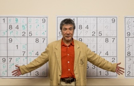 (FILES) In this file photo taken on September 29, 2012, Japanese puzzle manufacturer Maki Kaji poses for a picture during the first Sudoku national competition in Sao Paulo. - In a notice posted August 16, 2021, Nikoli said Maki Kaji died at home on August 10 after battling cancer, and a memorial service would be held at a later date -- Photo: Yasuyoshi Chiba/ AFP