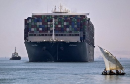 (FILES) This file picture taken on July 7, 2021 shows a view of the Panama-flagged MV 'Ever Given' container ship sailing near a felucca along Egypt's Suez Canal near the canal's central city of Ismailia, as it departs from the waterway -- Photo: Mahmoud Khaled/ AFP
