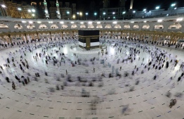 A long exposure photograph shows Muslim pilgrims circumambulating around the Kaaba, Islam's holiest shrine, at the Grand mosque in the holy Saudi city of Mecca during the annual hajj pilgrimage, on July 17, 2021. - The annual hajj pilgrimage, one of the five pillars of Islam, started with just 60,000 vaccinated Saudi residents allowed to take part this year because of the pandemic. For the second year in a row, Muslims from abroad have been excluded from the hajj, which drew 2.5 million pilgrims to Saudi Arabia in 2019 before the virus struck. (Photo by Fayez Nureldine / AFP)