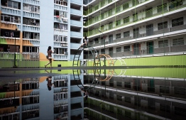 People take photos at a playground in a public housing estate in Hong Kong on August 29, 2021 -- Photo: Bertha Wang/ AFP