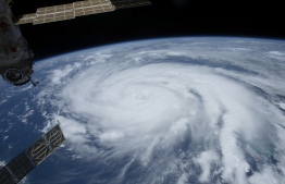 This NASA image released on September 1, 2021 shows Hurricane Ida pictured as a category 2 storm from the International Space Station as it orbited 263 miles above the Gulf of Mexico, with upper(L), the Nauka multipurpose laboratory module docked to the Earth-facing port of the Zvezda service module on August 28, 2021 -- Photo: / NASA / AFP