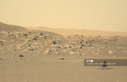 (FILES) In this file NASA photo obtained July 25, 2021, 2021 shows NASA's Ingenuity Mars Helicopter(R) captured by Mars Perseverance rover using its Left Mastcam-Z Camera, composed of a pair of cameras located high on the rover's mast, on June 15, 2021 (Sol 114). -- Photo by Handout / various sources / AFP