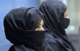 Afghan women airport workers are pictured at a security checkpoint of the airport in Kabul on September 12, 2021. - Of the more than 80 women working at the airport before Kabul fell to the Taliban on August 15, just 12 have returned to their jobs. -- Photo: Karim Sahib/ AFP