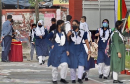 Students arrive to attend their classes at the Rajuk Uttara Model College in Dhaka on September 12, 2021, as Bangladesh schools reopened after 18 months in one of the world's longest shutdowns due to the Covid-19 coronavirus pandemic. (Photo by Munir Uz zaman / AFP)