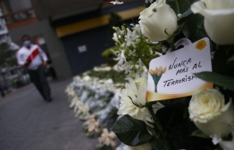 A card reading 'Terrorism Never Again' is seen among white roses at the site where a car bomb exploded on July 16, 1992 killing 25 people and wounding 155 on the deadliest Shining Path bombing, during a demonstration against terrorism in a commercial district of Lima on September 12, 2021: the suspected guerilla group member was killed in central Jungle region of Junin, according to Peru's military Twitter --  Photo: Gian Masko / AFP