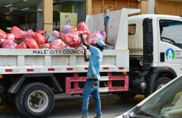 Male City Council's Waste Management Department employees at work.