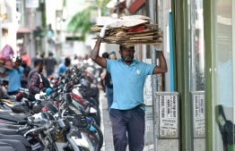 Male City Council Waste Management Department employees at work.