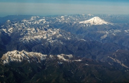 (FILES) This file photo taken on October 09, 2020, shows an aerial view of the Caucasus mountains in Russia with Mount Elbrus (5642 m) in the background. - Five climbers died after a blizzard on Mount Elbrus, Europe's highest peak, Russia's emergencies ministry said on September 24, 2021. -- Photo: Kirill Kudryavtsev/ AFP