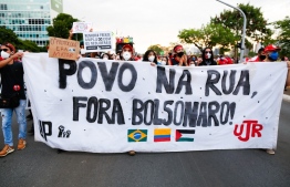 Demonstrators take part in a protest against Brazilian President Jair Bolsonaro's government in Brasilia, on October 2, 2021. Protests in Rio de Janeiro, Salvador, Sao Paulo and Brasilia, in addition to a hundred cities, were called by the "National Campaign Out with Bolsonaro", backed by a dozen left-wing parties, trade union centrals and the group Direitos Já! that brings together leaders from 19 banks.
Sergio Lima / AFP