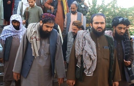Taliban officials are pictured outside a Shiite mosque after a suicide bomb attack in Kunduz on October 8, 2021. — Photo: AFP