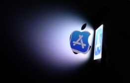(FILES) In this file photo taken on August 26, 2021 this illustration photo shows the Apple app store logo reflected from an iPhone onto the back of an iMac in Los Angeles. : US Judge Gonzales ordered Apple to loosen control on App Store payment options on Wednesday -- Photo: Chris Delmas/ AFP