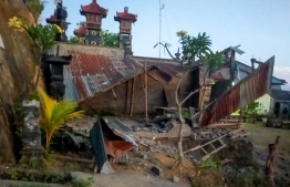 This handout picture taken and released on October 16, 2021 by the Bali regional disaster management agency (BPBD) shows collapsed houses after a 4.8 earthquake occurred in Karangasem, on the tourist island of Bali. -- Photo: BALI BPBD / AFP