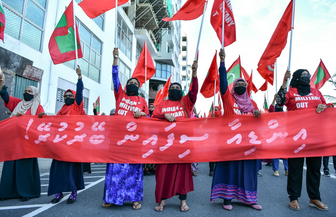 މާލެ- އޮކްޓޯބަރު 22، 2021: އިންޑިއާ ސިފައިން ރާއްޖޭން ބޭލުމަށް ގޮވާލައި މިއަދު މާލެގައި ބޭއްވި ހިނގާލުމުގައި އިދިކޮޅު ސަޕޯޓަރުން ބައިވެރިވަނީ، ގިނަ އަދަދެއްގެ މީހުން ބައިވެރިވި އެ ހިނގައިލުން ކުރިއަށް ދިޔައީ ފުލުހުންގެ އިރުޝާދާ އެއްގޮތަށް ސުލްހަވެރިކަމާ އެކު--. ފޮޓޯ: ނިޝާން އަލީ / މިހާރު