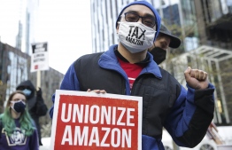 (FILES) In this file photo taken on March 26, 2021 Preston Sahabu, 27, with Academic Workers Union (UAW) 4121 at the University of Washington, is pictured during a rally at the Amazon Spheres and headquarters in solidarity with Amazon workers in Bessemer, Alabama, who hope to unionize, in Seattle, Washington.  -- Photo: Jason Redmond / AFP