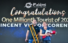 Vincent Victor Corentim Vitau and his wife Anna Vitau stop to take a photo while they are being celebrated for being the one millionth tourist to Maldives in 2021, on October 29 -- Photo: Fayaz Moosa / Mihaaru