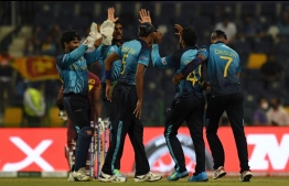 Sri Lanka's cricketers celebrates after the dismissal of West Indies' Dwayne Bravo during the ICC men’s Twenty20 World Cup cricket match between West Indies and Sri Lanka at the Sheikh Zayed Cricket Stadium in Abu Dhabi on November 4, 2021. -- Photo: Indranil Mukherjee / AFP