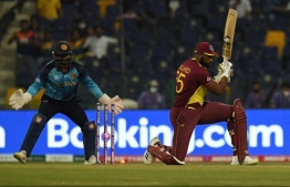 West Indies' captain Kieron Pollard (R) is bowled out by Sri Lanka's Wanindu Hasaranga de Silva (not pictured) during the ICC men’s Twenty20 World Cup cricket match between West Indies and Sri Lanka at the Sheikh Zayed Cricket Stadium in Abu Dhabi on November 4, 2021. Photo: Indranil Mukherjee / AFP