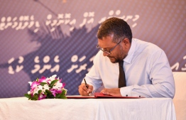 Economic Minister Fayyaz Ismail signs motion setting minimum wage in a ceremony held in Hotel Jen on Monday, November 8, 2021 -- Photo: Fayaz Moosa / Mihaaru
