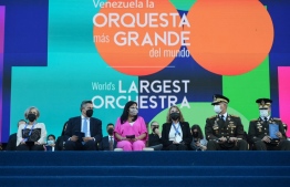 Venezuelan Vice-President Delcy Rodriguez (3-L) and Venezuela's Defence Minister Vladimir Padrino (2-R) attend the attempt of members of the National System of Orchestras of Venezuela to enter the Guinness Book of Records for the largest orchestra in the world, with more than 12,000 musicians, at the Military Academy of the Bolivarian Army in Fuerte Tiuna Military Complex, in Caracas, on November 13, 2021. -- Photo: Federico Parra / AFP