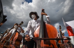 Members of the National System of Orchestras of Venezuela play during an attempt to enter the Guinness Book of Records for the largest orchestra in the world, with more than 12,000 musicians, at the Military Academy of the Bolivarian Army in Fuerte Tiuna Military Complex, in Caracas, on November 13, 2021. (Photo by Federico PARRA / AFP)