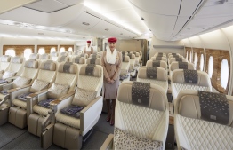 A cabin crew stands in an Emirates airplane: the airline lost  USD 1.6 billion between April and September of 2021, compared with losses of USD 3.4 billion during the same period in 2020.--  Photo: Emirates Airline