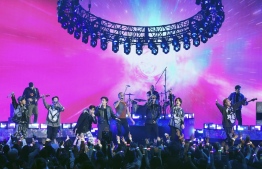 This handout photo courtesy of American Broadcasting Companies, Inc. / ABC shows British rock band perform with South Korean band BTS onstage during the 2021 American Music Awards at the Microsoft Theater on November 21, 2021 in Los Angeles. (Photo by American Broadcasting Companies, Inc. / ABC / AFP) / 