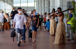 Traditional dancers in grass skirts welcome holidaymakers in Nadi on December 1, 2021, as Fiji opens its borders to international travellers for the first time since the Covid-19 pandemic swept the globe and devastated its tourism-reliant economy. -- Photo: Leon Lord / AFP