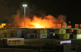 A picture released by the official Syrian Arab News Agency (SANA) on December 7, 2021 shows fire near containers of the Syrian port of Latakia. - An Israeli air strike hit a shipment of Iranian weapons in the Syrian port of Latakia on December 7, 2021, in the first such attack on the key facility, a war monitor said. The Israeli raid "directly targeted an Iranian weapons shipment in the container yard," the Syrian Observatory for Human Rights said. -- Photo: SANA / AFP)