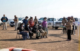 An instructor of Global Clearance Solutions (GCS) private demining company gives a workshop to children on how to report suspected cases of landmines and unexploded ordnances in an area near the village of Hassan-Jalad, north of Iraq's northern city of Mosul on November 29, 2021 -- Photo: Zaid Al-Obeidi / AFP