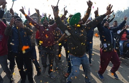 Farmers cheer as they prepare to leave the protest site at the Delhi-Haryana state border in Singhu on December 11, 2021, as Indian farmers formally ended year-long mass protests after Prime Minister Narendra Modi abandoned his push for agricultural reforms. -- Photo: Sajjad Hussain / AFP