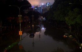 A general view shows cars in flood water caused by heavy rain in Kuala Lumpur early on December 19, 2021. -- Photo: Arif Kartono / AFP