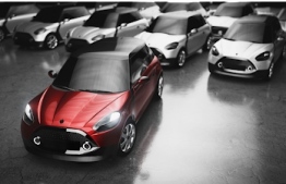 Image showing red car standing apart from other cars -