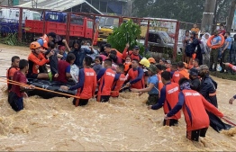 This handout photo taken on December 16, 2021 and received from the Philippine Coast Guard shows rescue workers evacuating residents from their flooded homes amid heavy rains brought by Super Typhoon Rai in Cagayan de Oro City, on the southern island of Mindanao. -- Photo: Handout / Philippine Coast Guard (PCG) / AFP