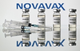 (FILES) This file illustration picture shows vials with Covid-19 Vaccine stickers attached and syringes with the logo of US biotech company Novavax, on November 17, 2020. -- Photo: Justin Tallis / AFP