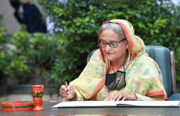 Prime Minister of Bangladesh Sheikh Hasina signs an agreement -- Photo: Nishan Ali/ Mihaaru