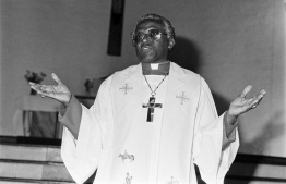 (FILES) In this file photo taken on June 23, 1985 South African activist and Nobel Peace Prize and Anglican Archbishop Desmond Tutu delivers a sermon, at the Regina Mundi Church, in Soweto, protesting against the South African raid into Botswana. - South African anti-apartheid icon Desmond Tutu, described as the country's moral compass, died on December 26, 2021, aged 90, President Cyril Ramaphosa said. -- Photo: Gideon Mendel / AFP