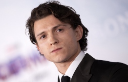 (FILES) In this file photo taken on December 13, 2021 English actor Tom Holland attends the "Spider-Man: No way home" premiere at the Regency Village and Bruin Theatres in Los Angeles. - The hit new "Spider-Man" became the first billion-dollar-grossing film of the pandemic era over the Christmas weekend, reaching the milestone while holding firmly to the North American box office top spot, industry watcher Exhibitor Relations said Sunday. -- Photo: Valerie Macon / AFP