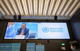 World Health Organization (WHO) Director-General Tedros Adhanom Ghebreyesus is seen on a giant screen during a press conference at the WHO headquarters in Geneva on December 20, 2021. - The World Health Organization chief called for the world to pull together and make the difficult decisions needed to end the Covid-19 pandemic within the next year. -- Photo: Fabrice Coffrini/ AFP
