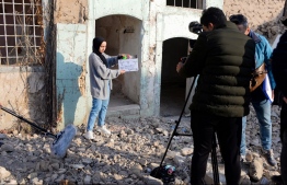 Students of a film school, prepare to shoot a scene, in the war-ravaged northern Iraqi city of Mosul, on December 15, 2021. - In a collaboration between the Mosul fine arts academy, a Belgian theatre company and UN cultural agency UNESCO, 19 students are getting a chance to make their first short films,  -- Photo: Zaid AL-Obeidi/ AFP