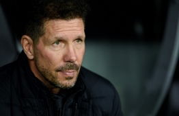 (FILES) In this file photo taken on December 12, 2021 Atletico Madrid's Argentinian coach Diego Simeone looks on during the Spanish league football match between Real Madrid CF and Club Atletico de Madrid at the Santiago Bernabeu stadium in Madrid. - Atletico Madrid's French forward Antoine Griezmann, along with four other including headcoach Diego Simeone, have tested positive to Covid-19, the club announced on December 30, 2021. -- Photo: Oscar Del Pozo / AFP