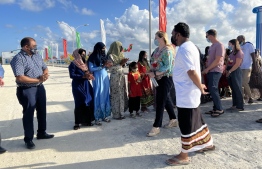 First homestay tourist welcomed to Dhiggaru by the local residents -- Photo: Mihaaru